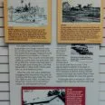 a sign with pictures of buildings and text